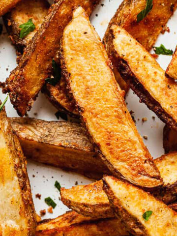 potato wedges in a white pan.