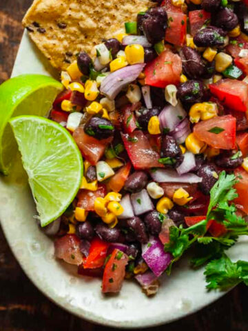 oven roasted corn and black bean salsa on a white serving platter.