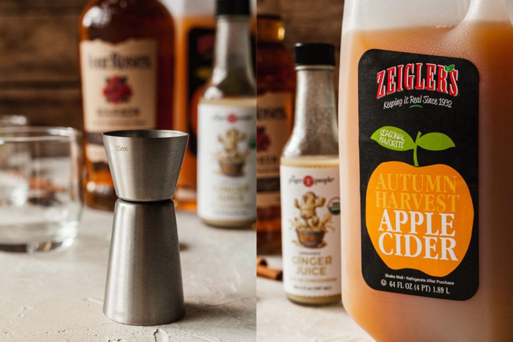 a jigger with ingredients for an apple cider cocktail