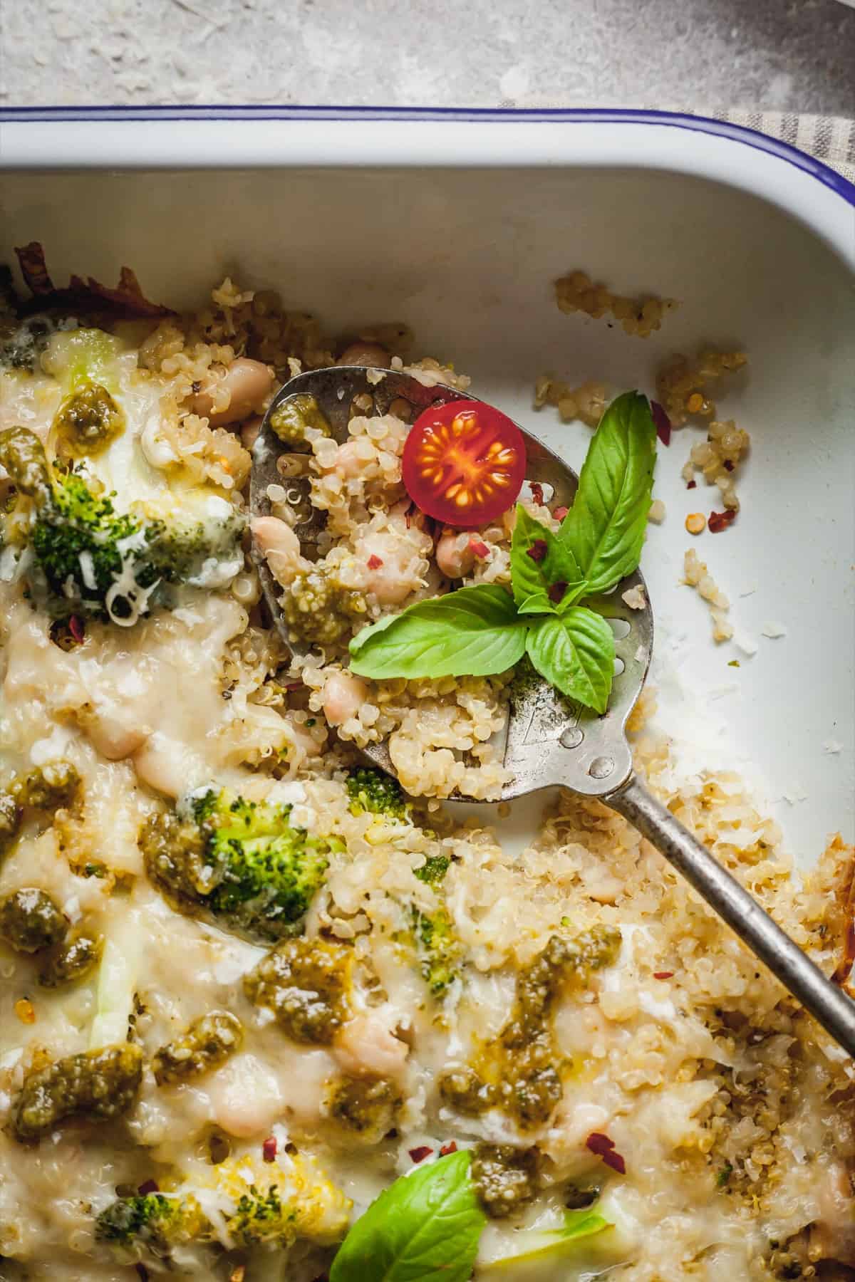 Broccoli quinoa casserole with a spoon in the casserole dish. 