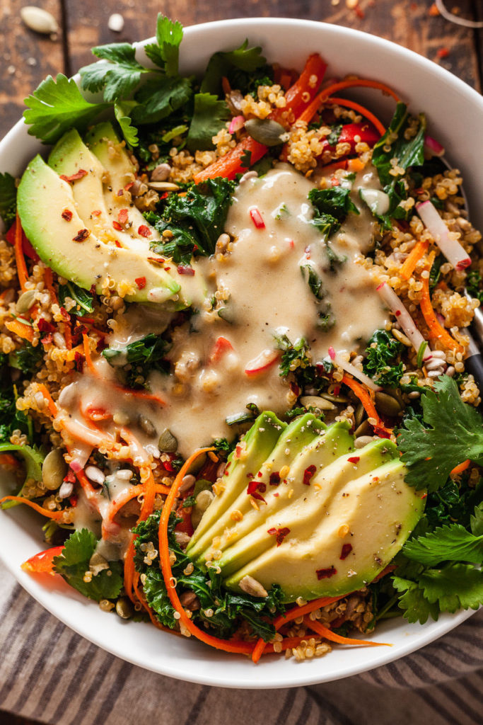 close up of lemon tahini dressing on a vegan salad