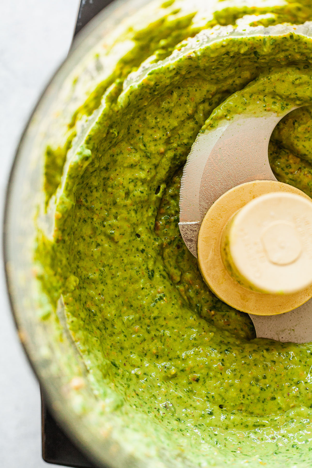 green avocado sauce in a food processor
