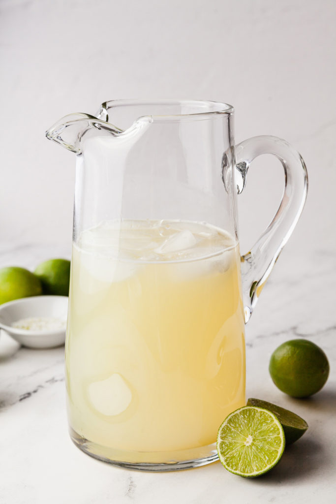 A pitcher of margaritas is just what you need to get your party started! This easy to remember recipe uses only four ingredients to make the perfect classic margarita in a big batch. Great for parties, Cinco de mayo, or ladies’ night! #cocktail #bigbatch #margaritas