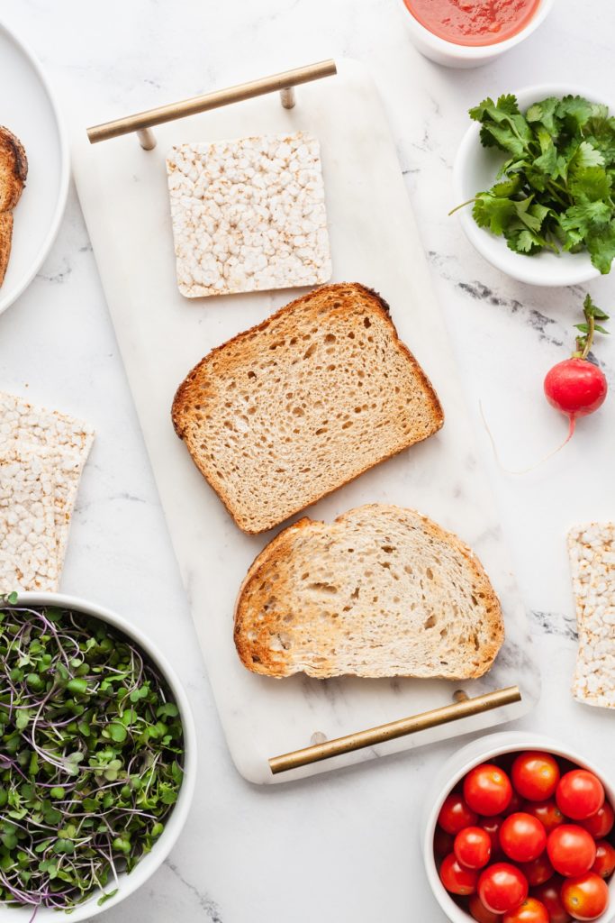 three slices of bread surrounded by veggies