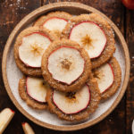 a plate of nutmeg ginger apple snaps on a wood table