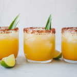 three glasses filled with pineapple margarita