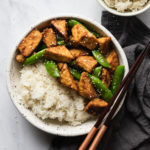 easy stir fried tempeh in a bowl with white rice and chopsticks