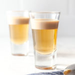 featured image of two shot glasses with buttery nipple shot