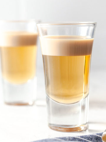 featured image of two shot glasses with buttery nipple shot