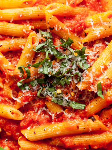 penne al pomodoro topped with basil and parmesan cheese