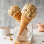 two ice cream cones with grape nut ice cream in glasses