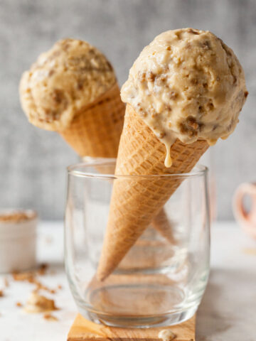 two ice cream cones with grape nut ice cream in glasses