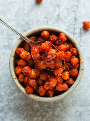 a bowl of gochujang crispy chickpeas with a spoon