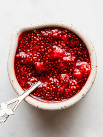a small bowl of strawberry chia jam with a spoon