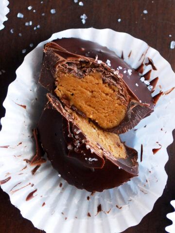 an almond butter cup cut in half on a white wrapper