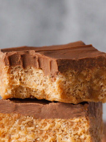 a stack of Scotcheroos with a bite taken out of the top square