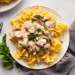 a plate of halloumi stroganoff served over egg noodles
