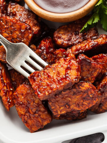 slices of bbq tempeh on a fork