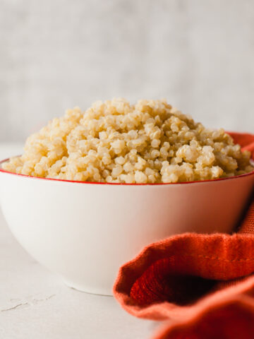 instant pot cooked quinoa in a bowl next to a red cloth napkin