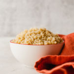 instant pot cooked quinoa in a bowl next to a red cloth napkin