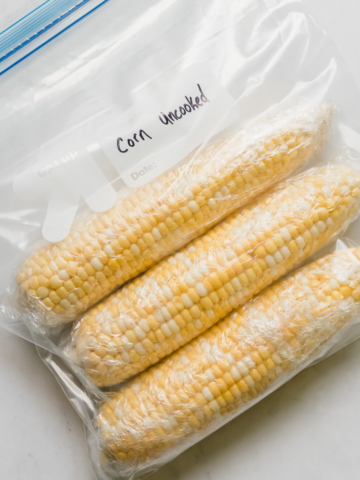 a ziplock bag of three ears of frozen corn on the cob
