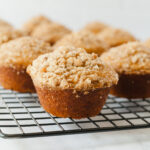 Vegan pumpkin muffins on a cooling rack.