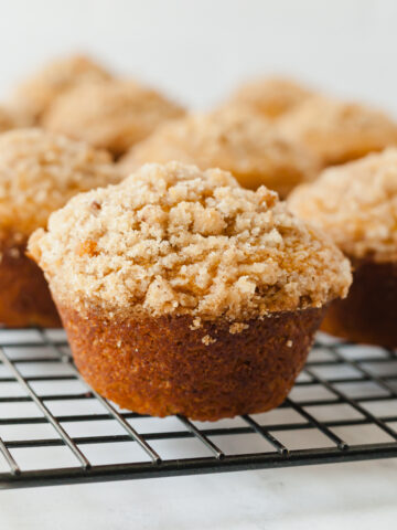 Vegan pumpkin muffins on a cooling rack.