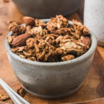 Vanilla almond granola in a small gray bowl.