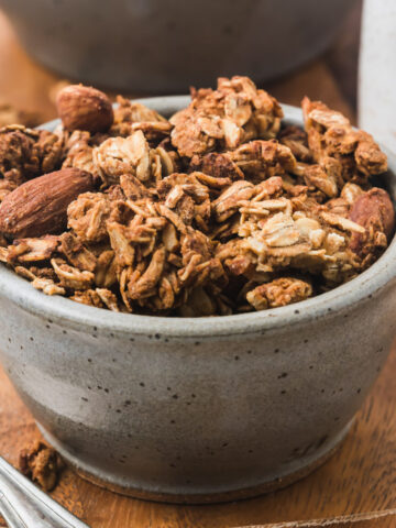 Vanilla almond granola in a small gray bowl.