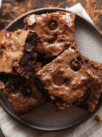Squares of dark chocolate brownies on a plate.