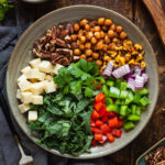 All the components of a cajun salad in a bowl prior to being mixed with dressing.