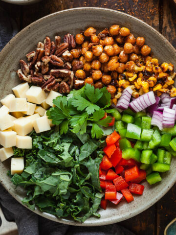 All the components of a cajun salad in a bowl prior to being mixed with dressing.
