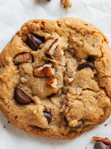 Top down view of a pecan chocolate chip cookie.
