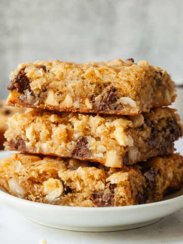 A stack of three congo bars on a white plate.