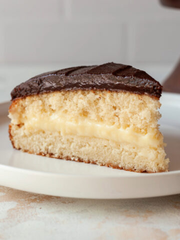 A slice of Boston cream pie on a plate.