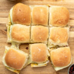 9 vegetarian cheese sliders on a cutting board.