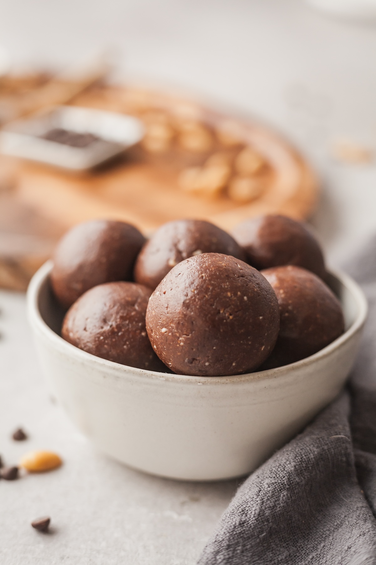 Chocolate peanut butter protein balls in a small bowl.