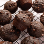 Mini chocolate muffins on a cooling rack.