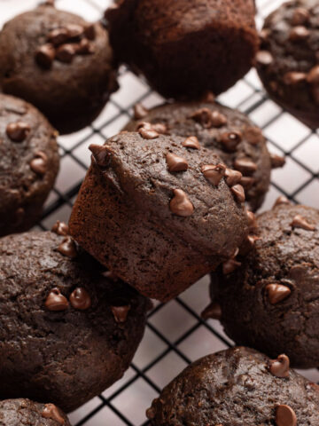 Mini chocolate muffins on a cooling rack.