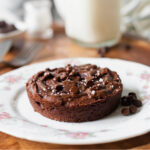 Single serve vegan brownie on a plate next to a fork.