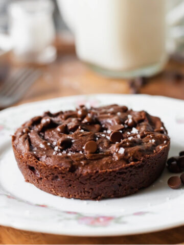 Single serve vegan brownie on a plate next to a fork.