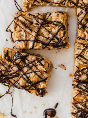 Healthy peanut butter breakfast bars on a sheet of parchment paper.