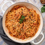 A large white pot of Spaghetti alla Ceci topped with fresh parsley.