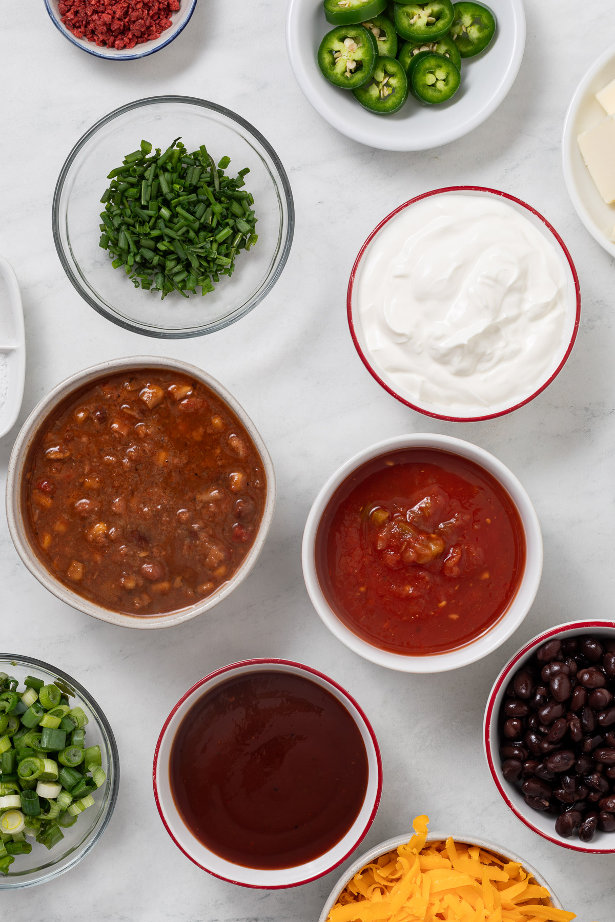 Various toppings in individual bowls.