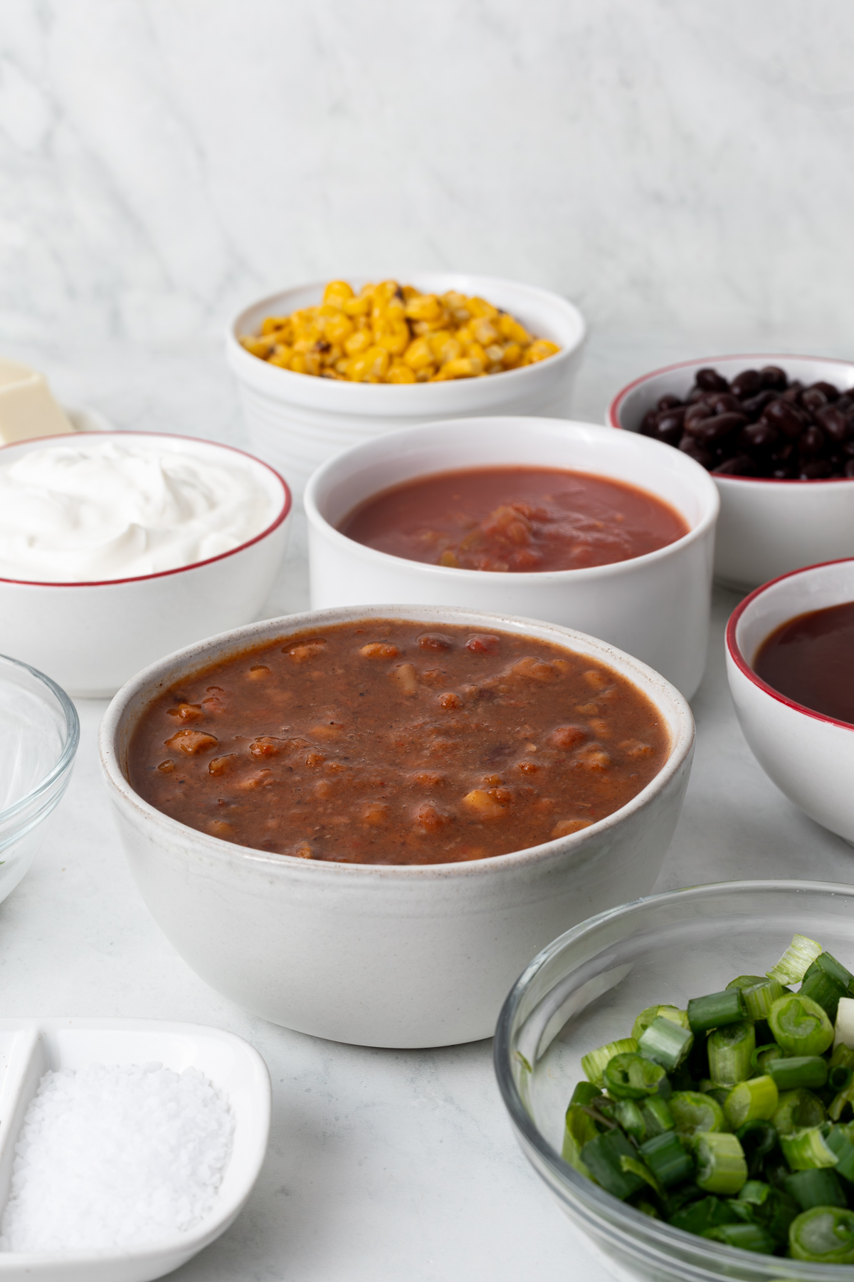 Various toppings in individual bowls.