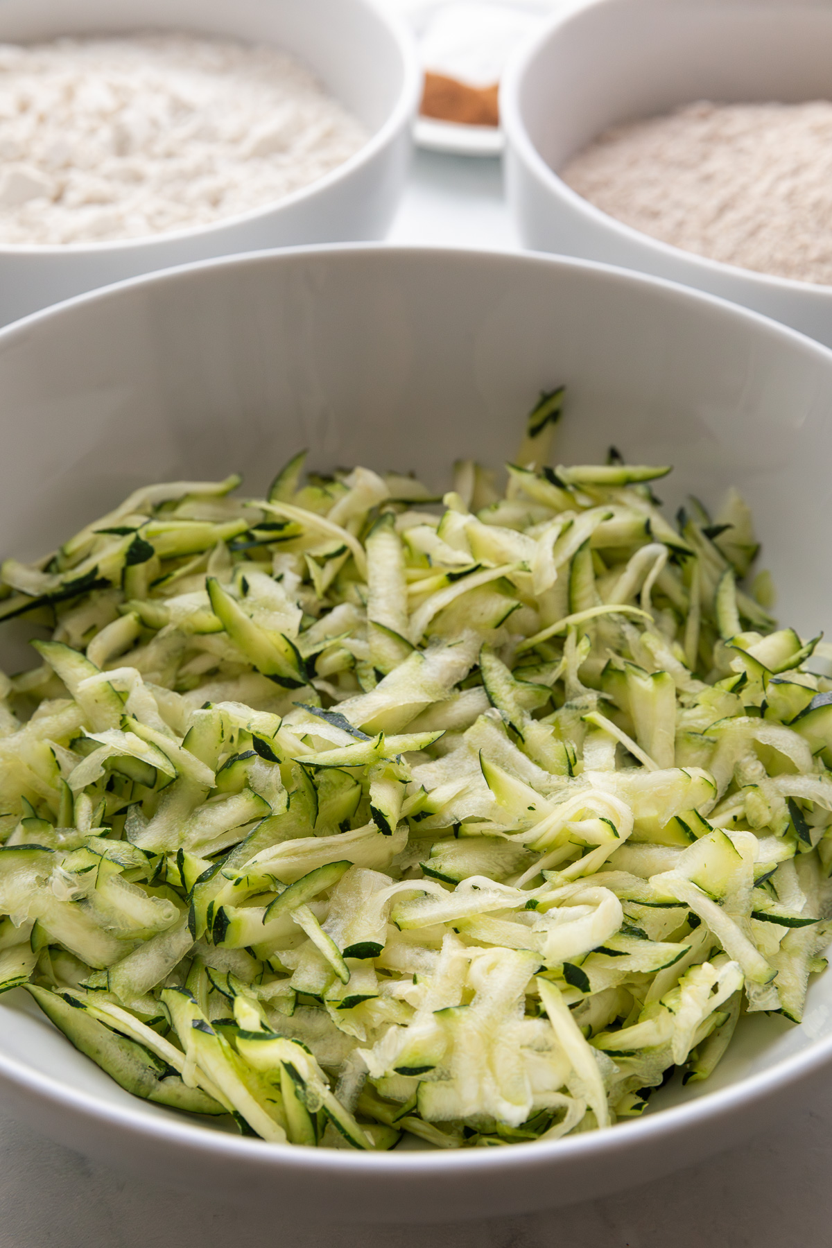 Shredded zucchini in a bowl.