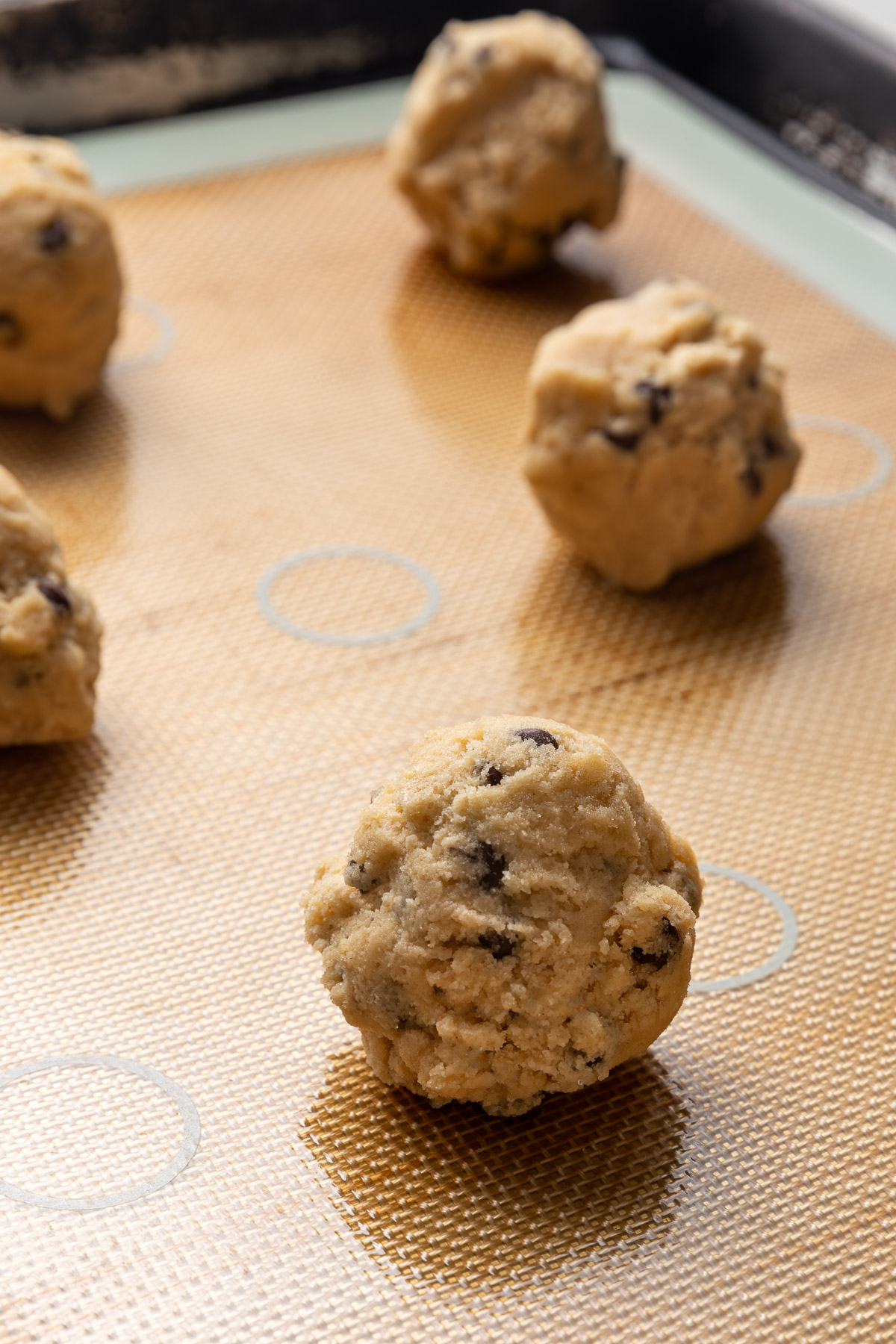 Balls of cookie dough on a baking sheet.