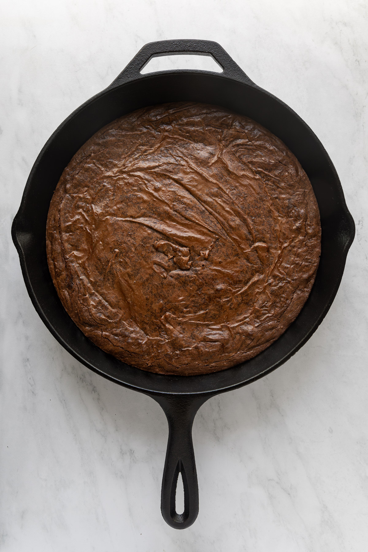 Brownie baked in a cast iron skillet.