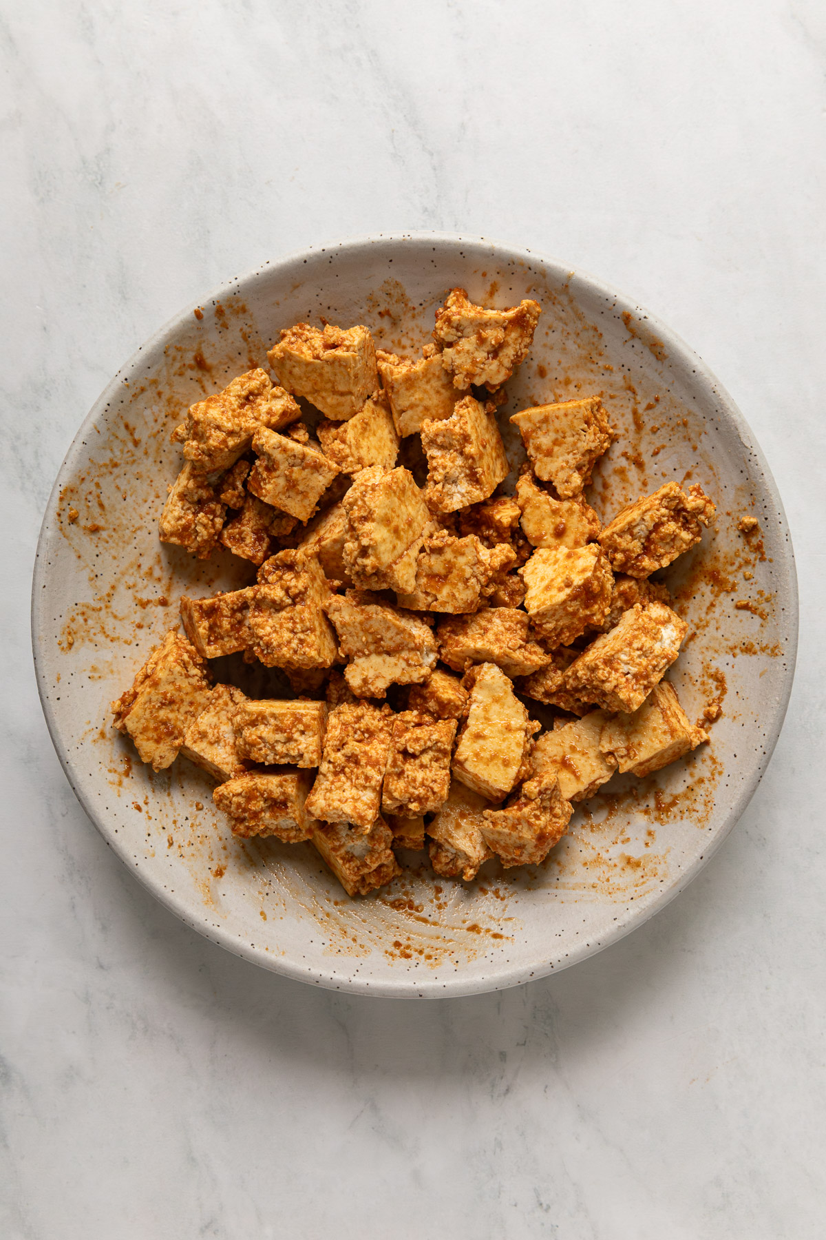 Marinated tofu nuggets in a bowl.