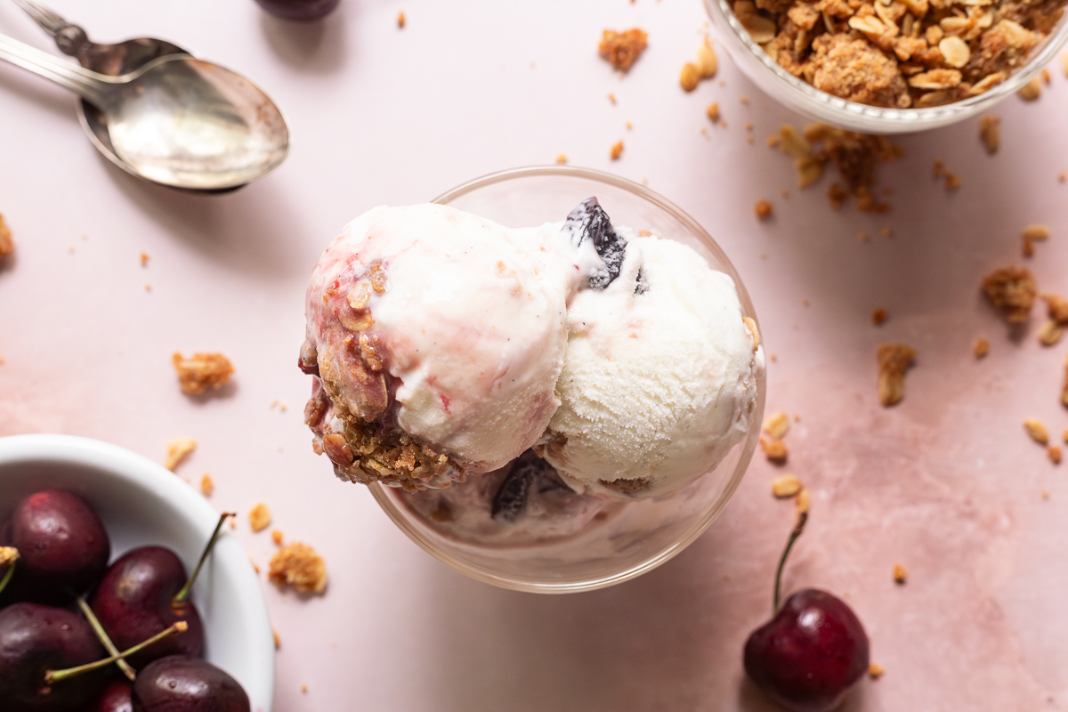 Three scoops of cherry crisp ice cream in a dish.